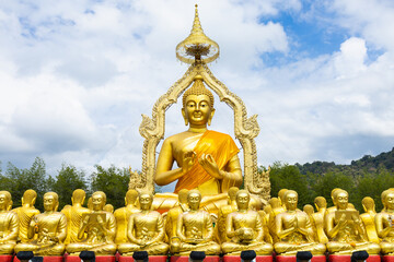 Lot of Golden Statue of Buddha sitting in meditation Belief Faith and Worship concept. Big buddha Press the hands together at chest In sign of respect religion culture