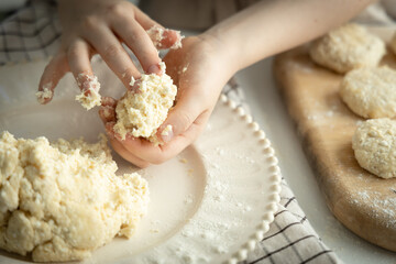 The girl makes a dough for cake baking.