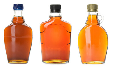 Set with bottles of tasty maple syrup on white background