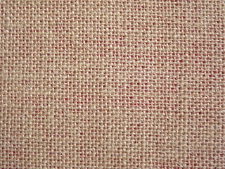 Jute fabric with pink undertone close-up as background