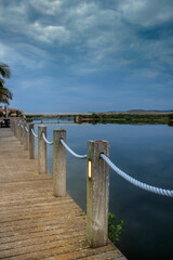 Overcast sunrise over Mossel bay lagoon from a boardwalk with bridge in background. Mossel bay, Western Cape, South Africa
