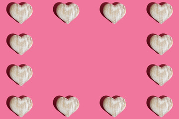 Seamless pattern made of wooden hearts  on pink background. Love or Valentine's Day concept. Flat lay, copy space.
