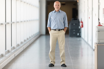 full-length portrait of a man standing in the hallway inside a n