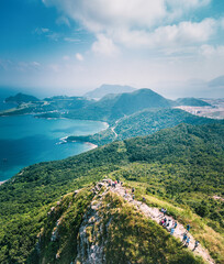 People walking on Footpath on a sharp mountain in Clear Water Bay, Sai Kung, Hong Kong. Hiking destination, clear weather in Autumn, Epic View