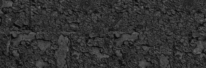 Black weathered wall wide texture. Old cracked peeling paint surface panorama. Gloomy dark abstract grunge banner background