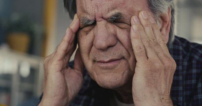 Man with headache close up view