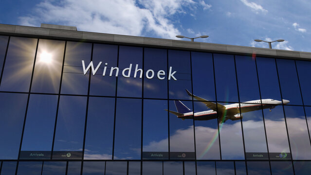 Airplane landing at Windhoek Namibia airport mirrored in terminal