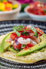 Mexican tortilla with prawns and avocado and salsa