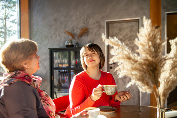 Mature women sitting in   cafe with   cup of coffee