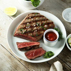 Grilled beef steak with tomato sauce	