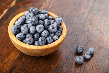 Blueberry antioxidant organic superfood in a wood bowl concept for healthy eating and nutrition. Concept for healthy eating and nutrition