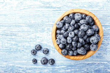 Freshly picked blueberries in a wooden bowl. Healthy berry, organic food, antioxidant, vitamin