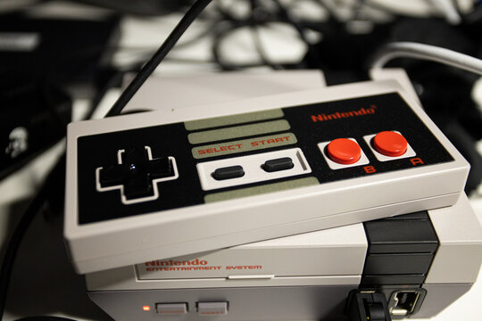 Retro gaming. 8 bit Nintendo Entertainment System Game controller with red buttons. Mini NES with copy space