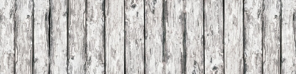 Light rough grainy wooden board wide banner texture. Old knotty weathered wood abstract rustic vintage background