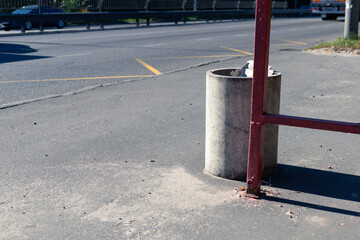Concrete trash bin next to the road