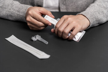 Close up of a person using coronavirus covid-19 rapid antigen home test