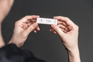 Close up of holding express antigen covid test, negative result