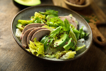 Healthy green salad with chicken and avocado