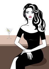 Girl sitting at the table with a cocktail.