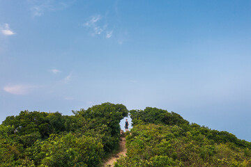 Hiking man on peak alone. Free explorer in countryside. located in Clear Water Bay, Hong Kong