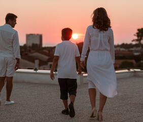 Fototapeta premium Happy family enjoys and spends time together on the roof of the house. Selective focus 
