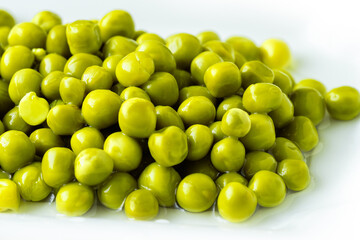 White bowl with canned green peas. Fermented food