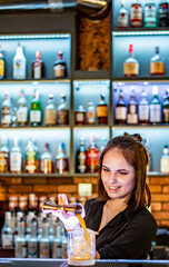young woman bartender Making Cocktail in bar