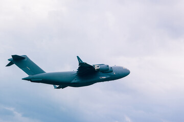 Big grey plane in a cloudy sky. without identification marks