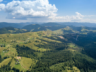 Fototapeta premium Green mountains of Ukrainian Carpathians in summer. Sunny day. Aerial drone view.