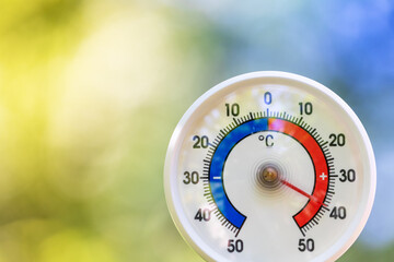 Outdoor thermometer shows hot summer temperature