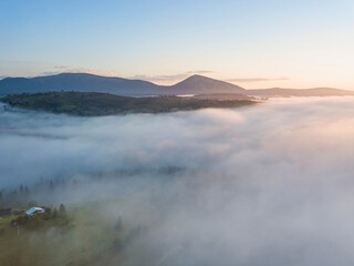 Obraz premium Sunrise over the fog in the Ukrainian Carpathians. Aerial drone view.