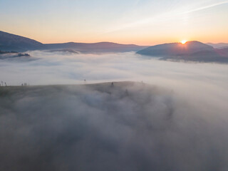Sunrise over the fog in the Ukrainian Carpathians. Aerial drone view.