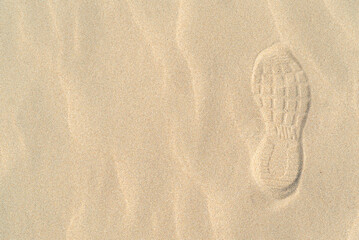 Footprint from shoes on the sand top view from copy space