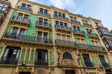 Fototapeta na wymiar A view of building balconies in the centre of Alicante on a spring day