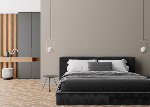 Empty grey wall in modern and cozy bedroom. Mock up interior in minimalist, contemporary style. Free space, copy space for your picture, text, or another design. Bed, lamps. 3D rendering.