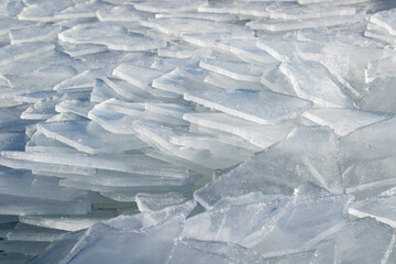 Obraz premium Broken ice pieces on the ground in early spring