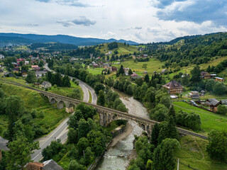 Old railway bridge in the mountains. Ukrainian Carpathians. Aerial drone view.