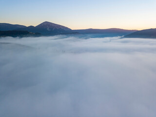 Sunrise over the fog in the Ukrainian Carpathians. Aerial drone view.