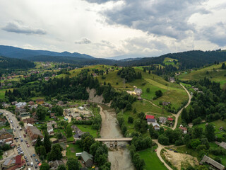 Fototapeta premium Settlement in the mountains of the Ukrainian Carpathians. Aerial drone view.
