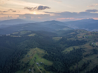 Fototapeta premium Sunset over the mountains in the Ukrainian Carpathians. Evening. Aerial drone view.
