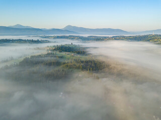 Morning fog in the Ukrainian Carpathians. Aerial drone view.
