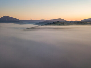 Obraz premium Sunrise over the fog in the Ukrainian Carpathians. Aerial drone view.