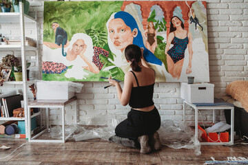 Pretty female artist in her art studio