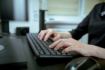  Female hands or woman office worker typing on the keyboard