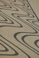 Decorative sidewalk with curved lines.