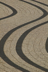 Fototapeta na wymiar Decorative sidewalk with curved lines.