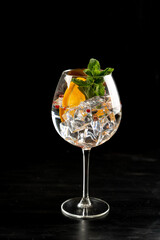 Modern Cocktail gin tonic herb spices fishbowl glass plain background