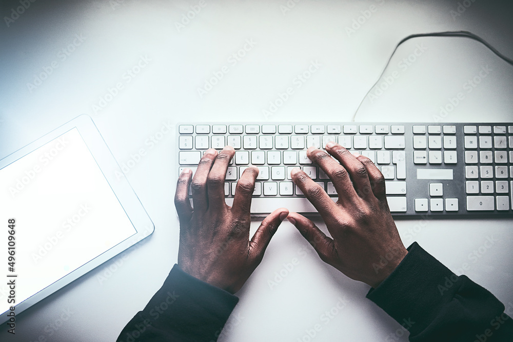 Poster fastest fingers on the web. high angle shot of an unrecognizable man typing on a keyboard while work