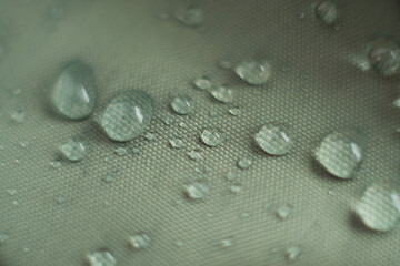 Fototapeta na wymiar waterproof fabric with waterdrops. non woven fabric water texture background Water drops on waterproof nylon fabric. soft focus