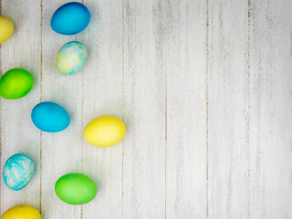 Multicolored painted eggs on a gray background. Easter concept
